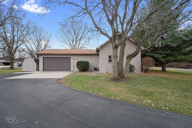 view of front facade with a garage, a front lawn, and a storage unit