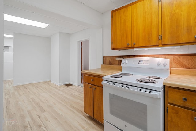 kitchen featuring light hardwood / wood-style floors and white range with electric stovetop