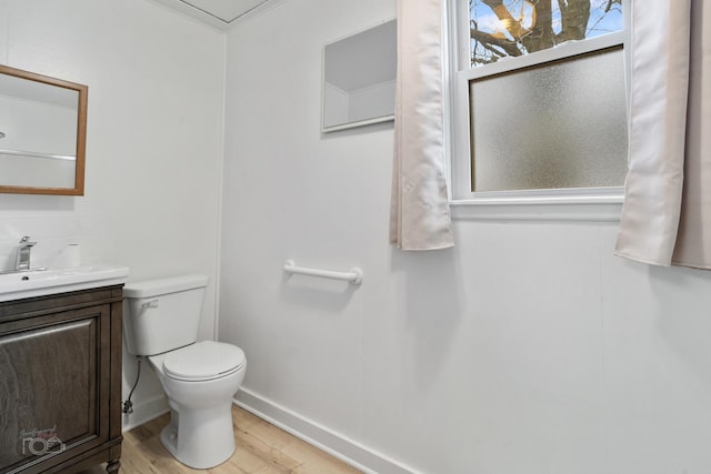 bathroom featuring hardwood / wood-style flooring, vanity, and toilet