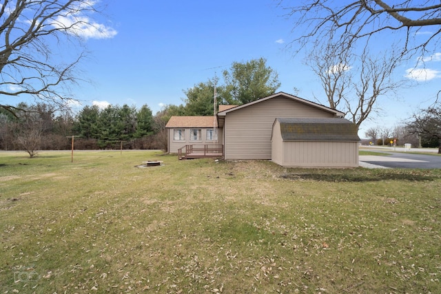 view of property exterior with a storage shed and a lawn