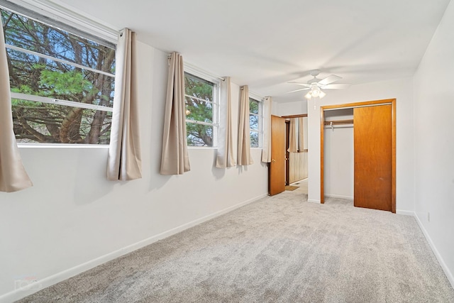 unfurnished bedroom with carpet floors, ceiling fan, and a closet