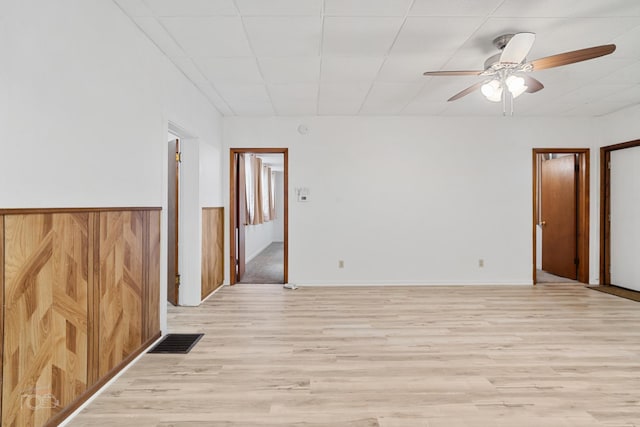 spare room featuring ceiling fan and light hardwood / wood-style flooring