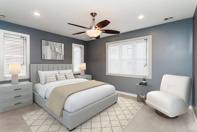 bedroom with light colored carpet and ceiling fan