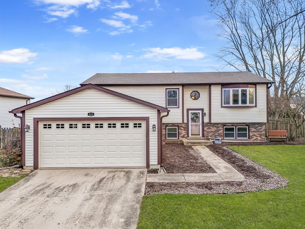 split foyer home featuring a front yard and a garage