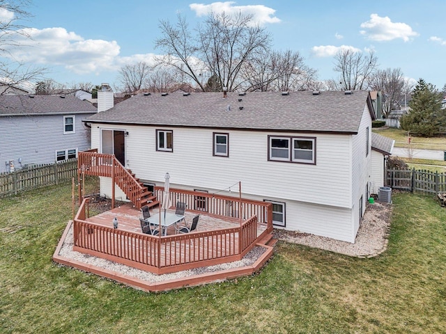 rear view of house with a lawn, cooling unit, and a wooden deck