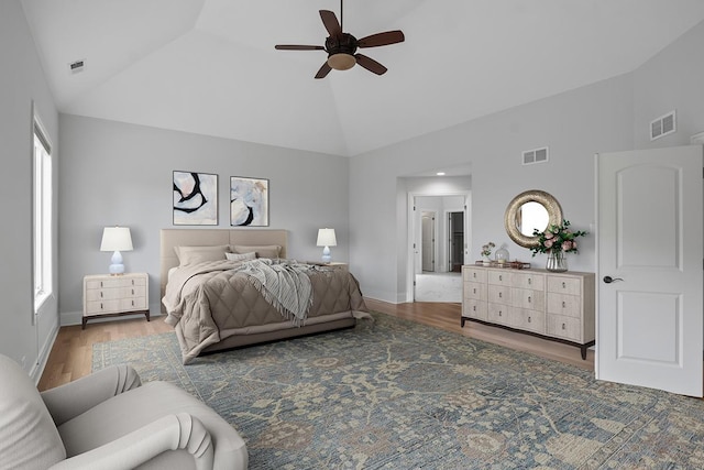 bedroom featuring ceiling fan, dark hardwood / wood-style floors, and high vaulted ceiling