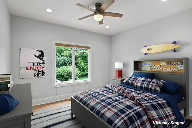 bedroom with wood-type flooring and ceiling fan