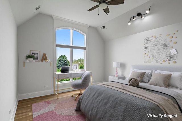 bedroom featuring wood-type flooring, vaulted ceiling, and ceiling fan