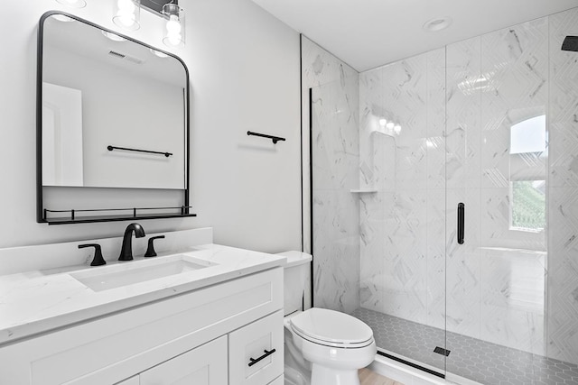 bathroom featuring walk in shower, vanity, and toilet