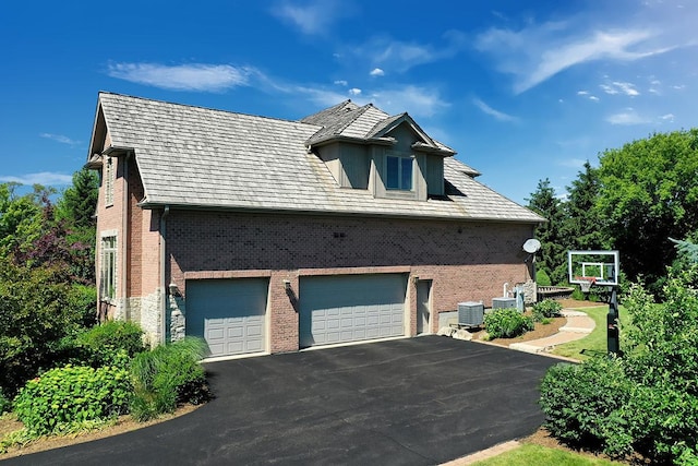 view of property exterior featuring a garage and central air condition unit