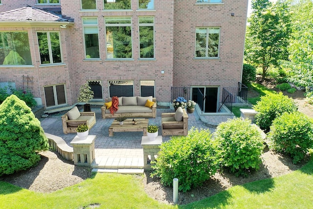 back of house featuring an outdoor living space and a patio area