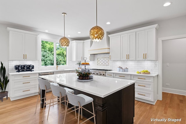 kitchen featuring a center island, white cabinets, and stainless steel gas cooktop