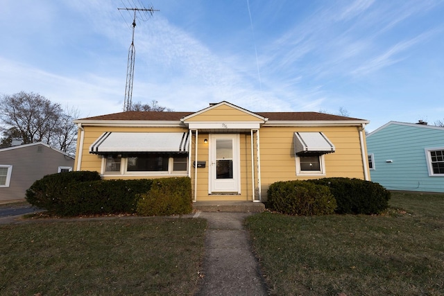 bungalow-style house with a front yard