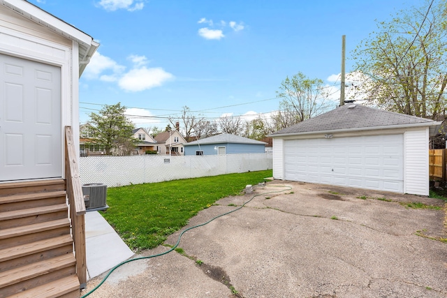 garage featuring central AC unit and a lawn