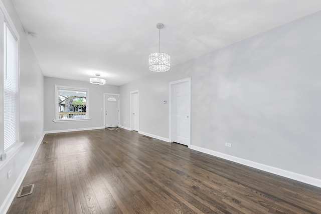 interior space with dark hardwood / wood-style flooring and an inviting chandelier