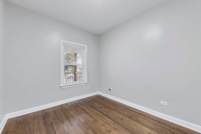 unfurnished room with dark hardwood / wood-style flooring