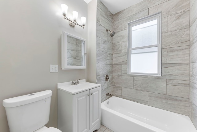 full bathroom featuring vanity, tiled shower / bath combo, and toilet