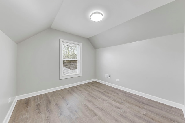 bonus room featuring light hardwood / wood-style floors and vaulted ceiling