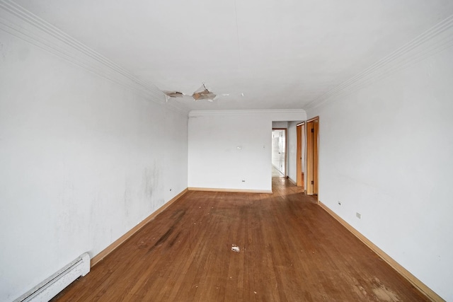 spare room featuring hardwood / wood-style flooring, ornamental molding, and a baseboard heating unit