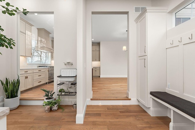 mudroom with light hardwood / wood-style floors