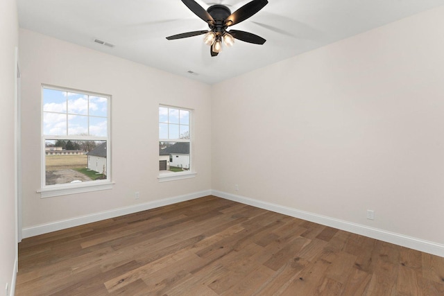 empty room featuring ceiling fan and dark wood-type flooring