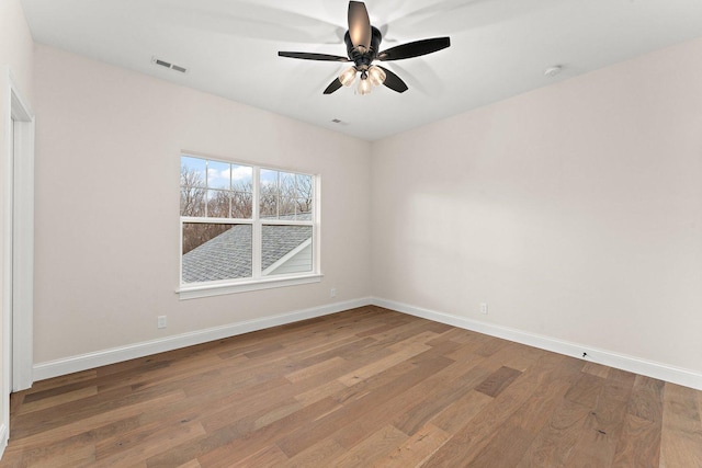 unfurnished room with hardwood / wood-style floors and ceiling fan