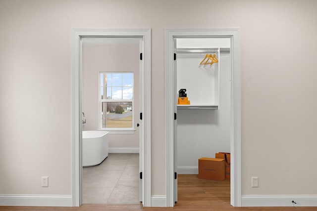 corridor featuring light tile patterned flooring