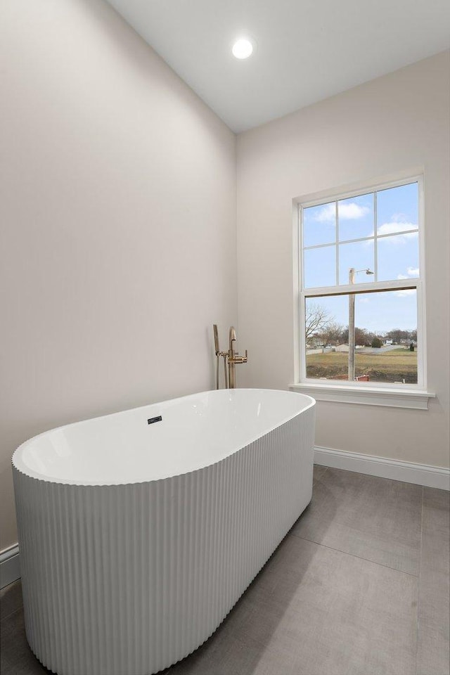 bathroom featuring tile patterned flooring and a tub