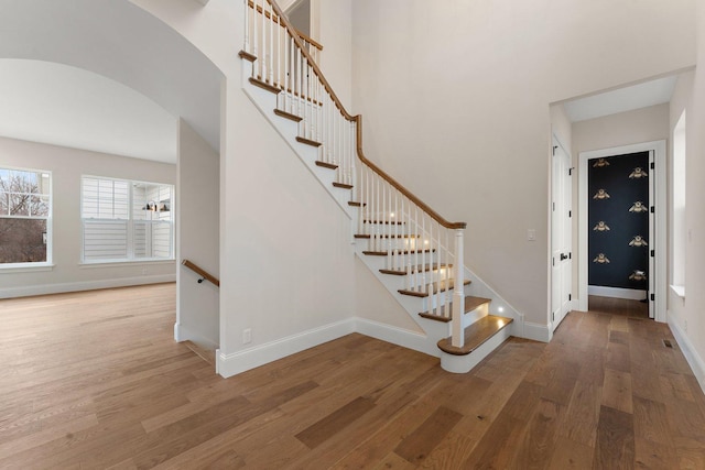 staircase with hardwood / wood-style floors