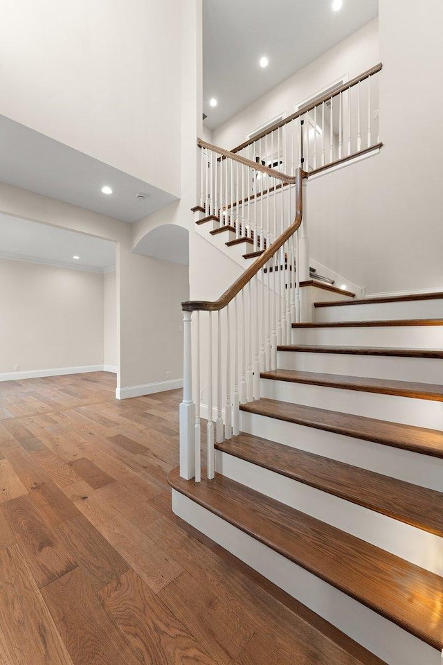 staircase with hardwood / wood-style flooring