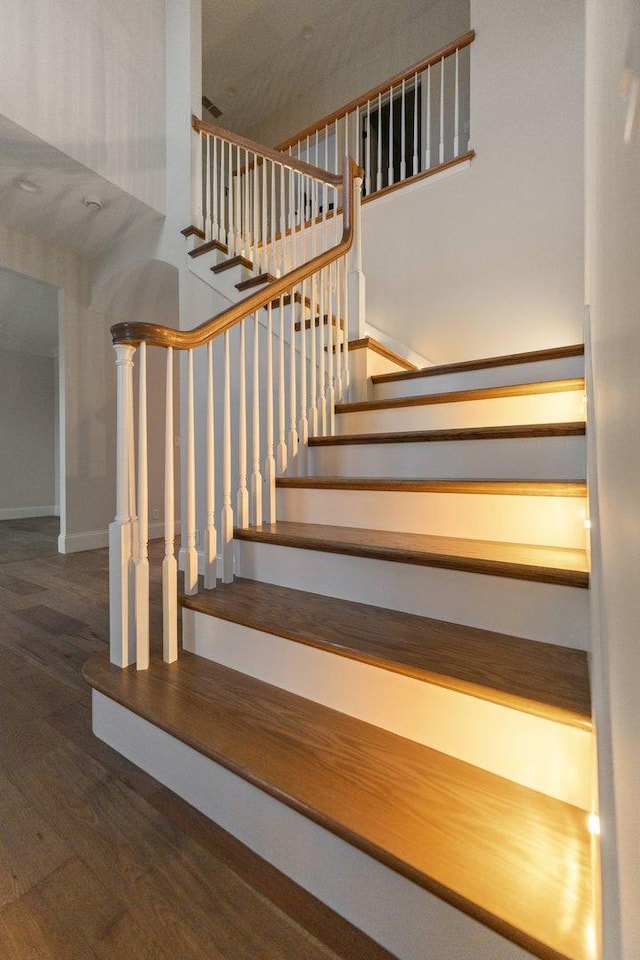 stairs featuring hardwood / wood-style flooring