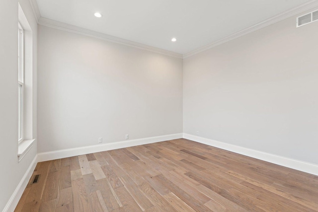 spare room featuring light hardwood / wood-style floors and ornamental molding