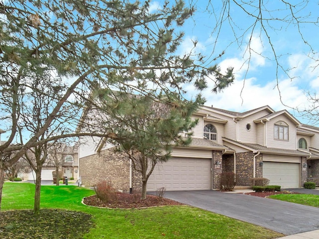 view of front of property featuring a front yard and a garage