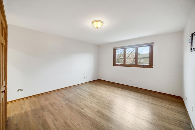 spare room with light hardwood / wood-style flooring