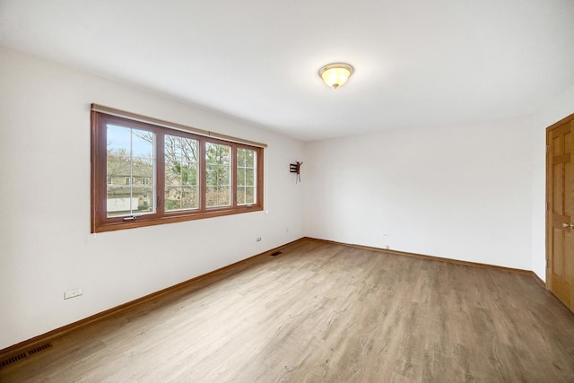 unfurnished room with light wood-type flooring