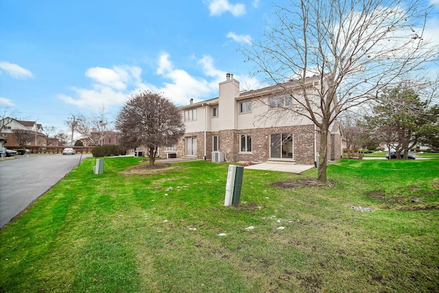 rear view of property featuring a lawn