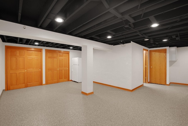 basement with white fridge