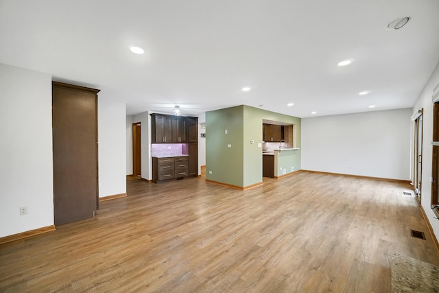 unfurnished living room featuring light wood-type flooring