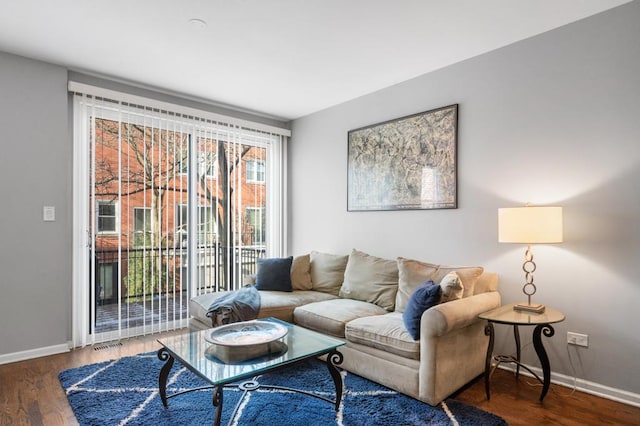 living room with dark hardwood / wood-style flooring