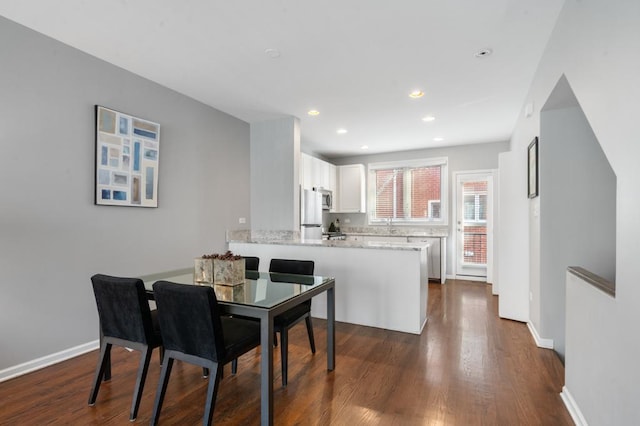 dining area featuring dark hardwood / wood-style flooring