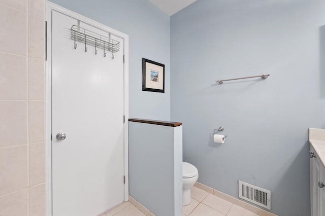 bathroom featuring tile patterned flooring, vanity, and toilet