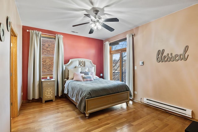 bedroom featuring ceiling fan, light hardwood / wood-style floors, access to outside, and a baseboard radiator