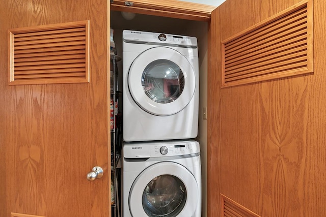 laundry room featuring stacked washer / drying machine