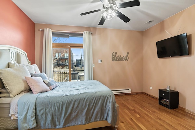 bedroom with ceiling fan, a baseboard radiator, access to outside, and light wood-type flooring