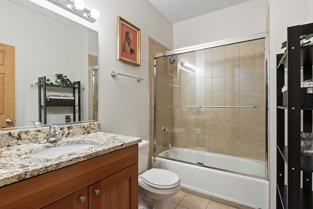 full bathroom with toilet, combined bath / shower with glass door, tile patterned flooring, and vanity