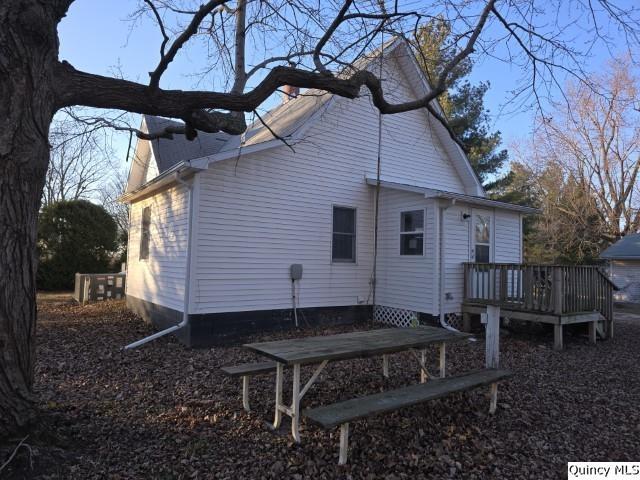 view of side of home with a deck