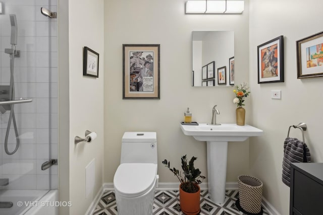 bathroom featuring toilet and baseboards