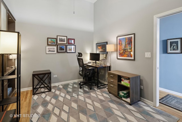 office space featuring light wood-style floors and baseboards