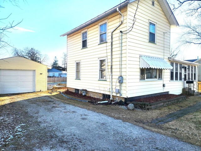 view of front of house featuring an outbuilding, a front lawn, and a garage