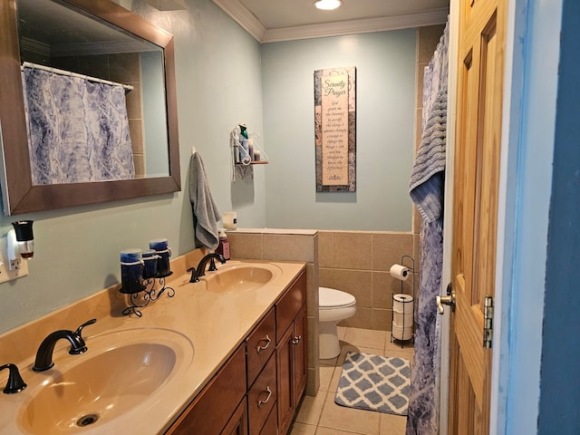 full bathroom featuring ornamental molding, tile patterned flooring, a sink, and tile walls